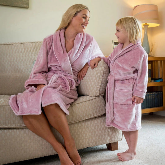 mother and daughter in matching pink fleece robes