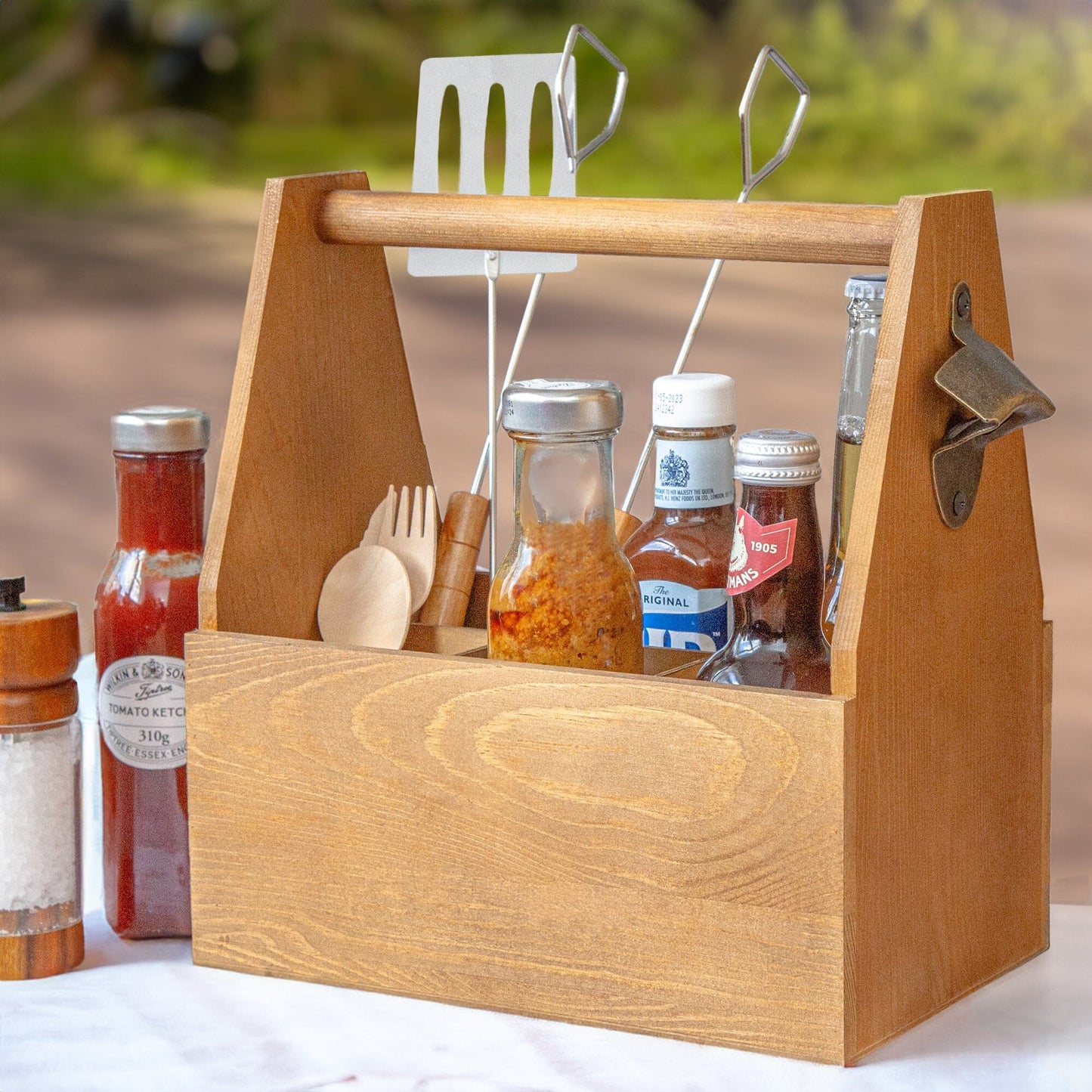 6-Bottle Carrier with Built-in Opener on a table outside with BBQ props