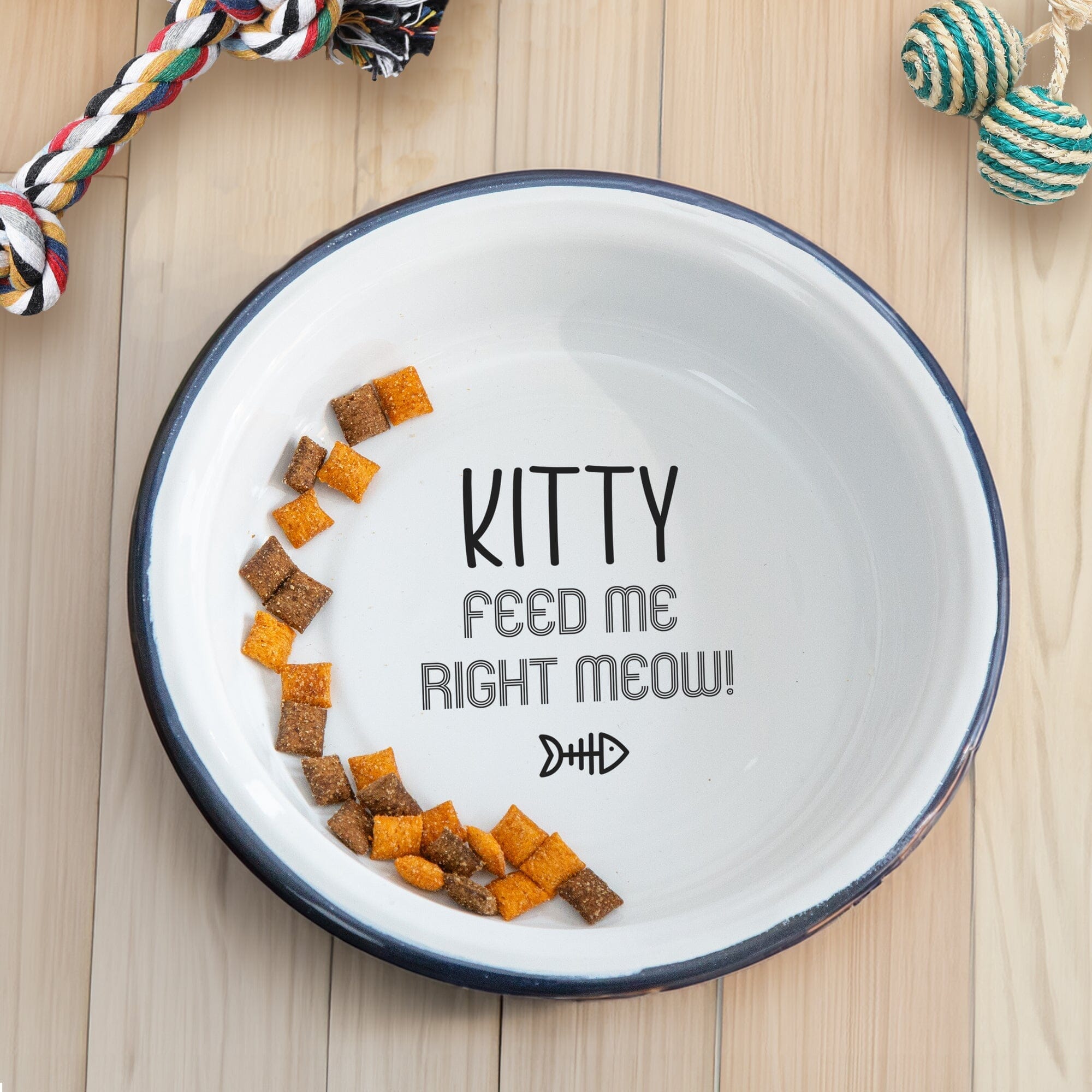Personalised Enamel Cat Bowl on the wooded floor with cat toys around