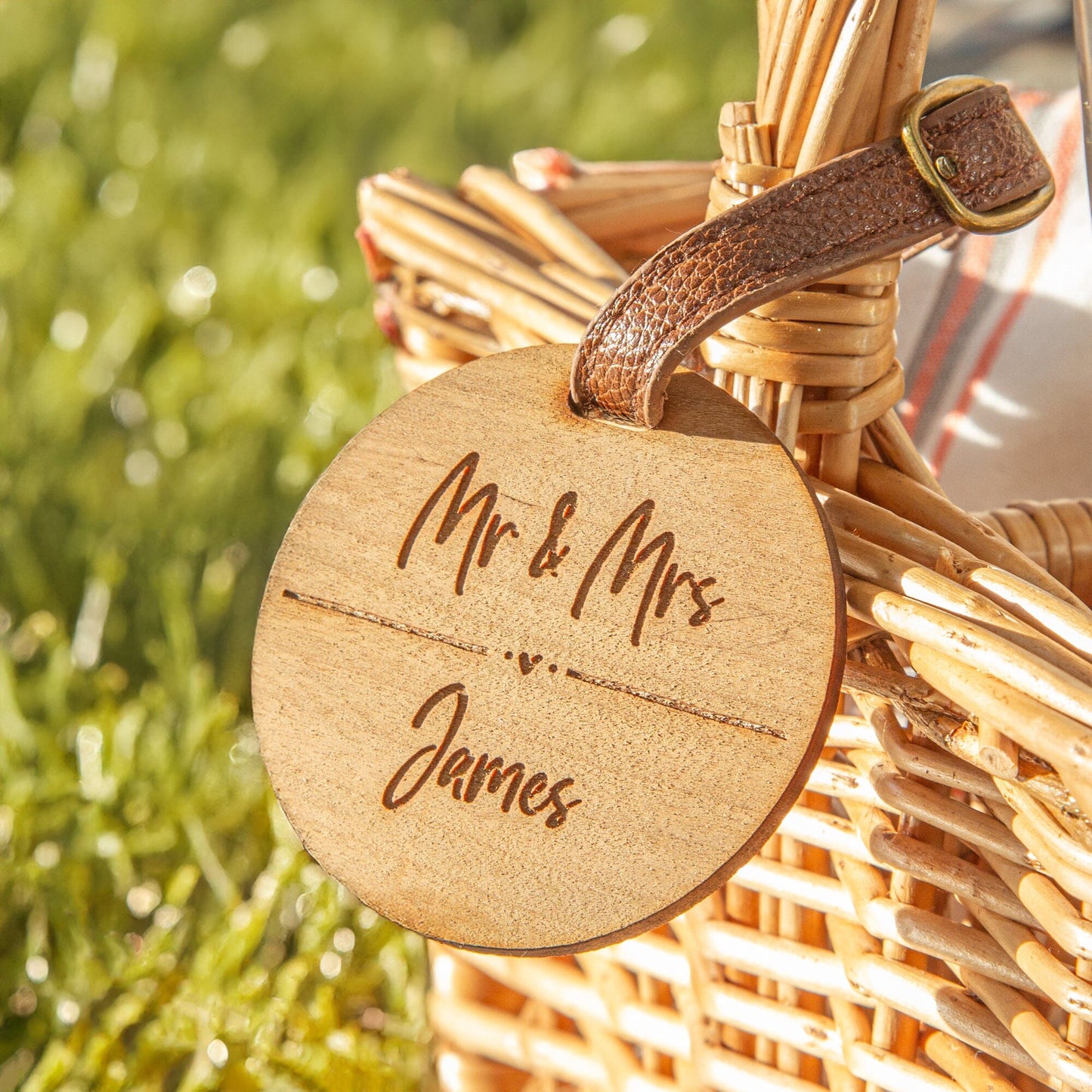 A closeup of the personalised round cherry wood veneer tag