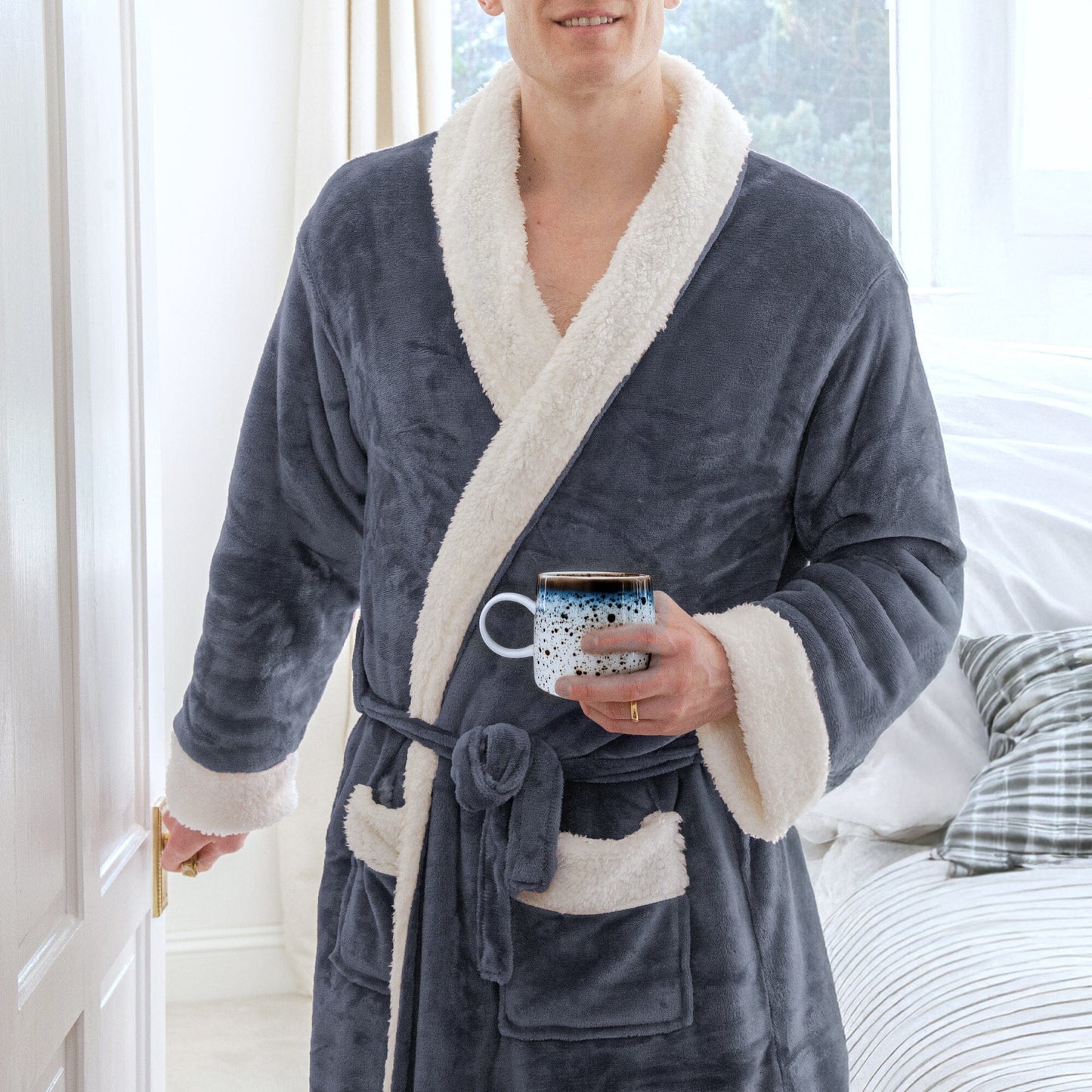 man wearing a sherpa robe holding a mug