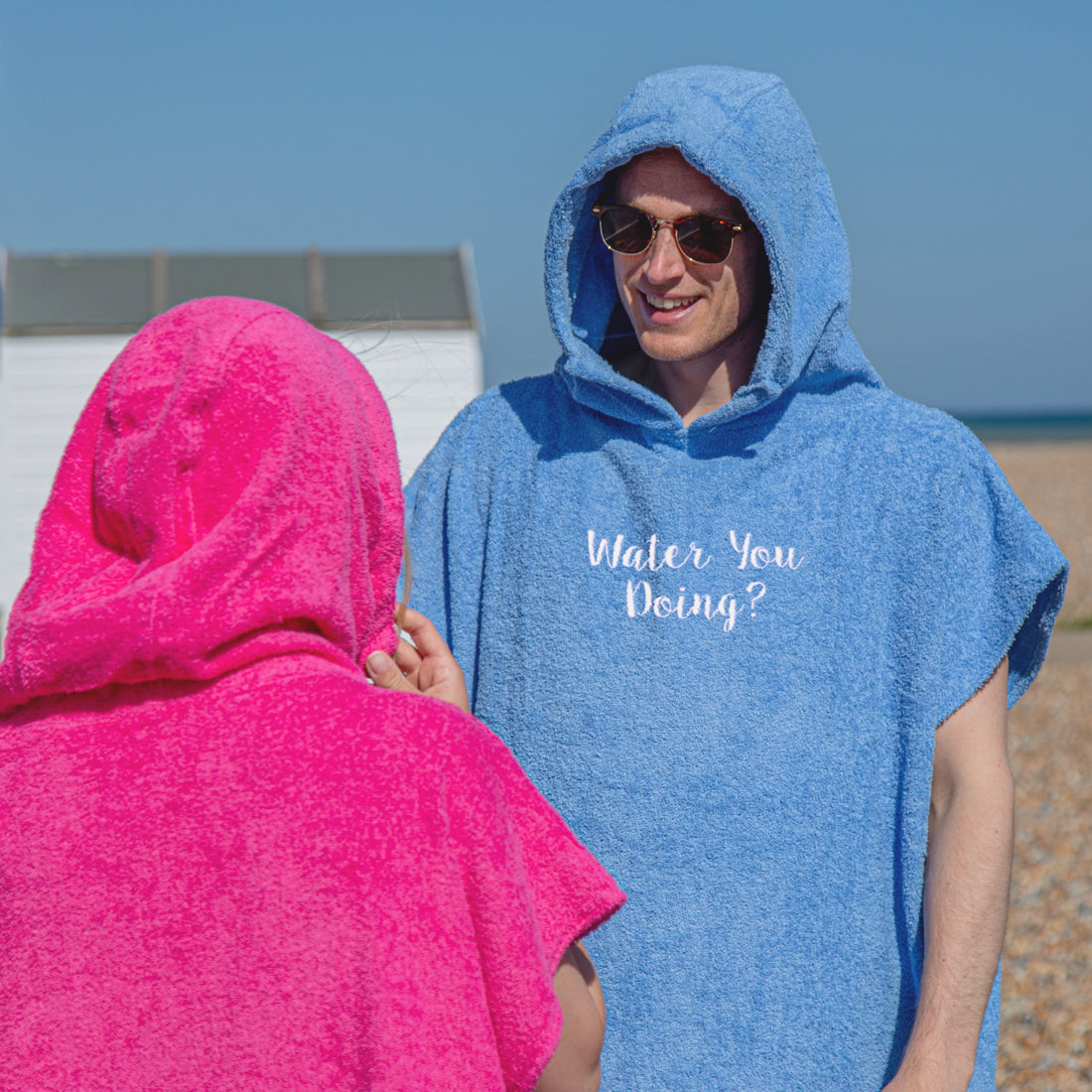 man wearing personalised changing robe at the beach