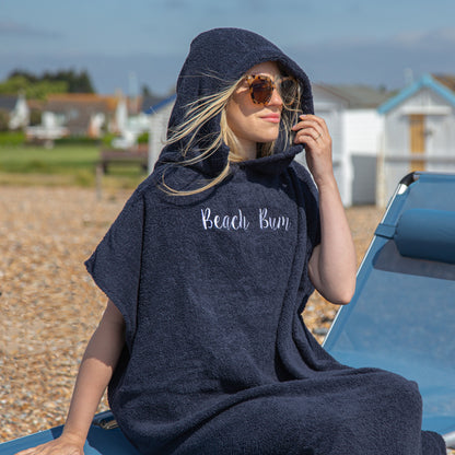 woman in sunglasses wearing personalised changing robe at the beach