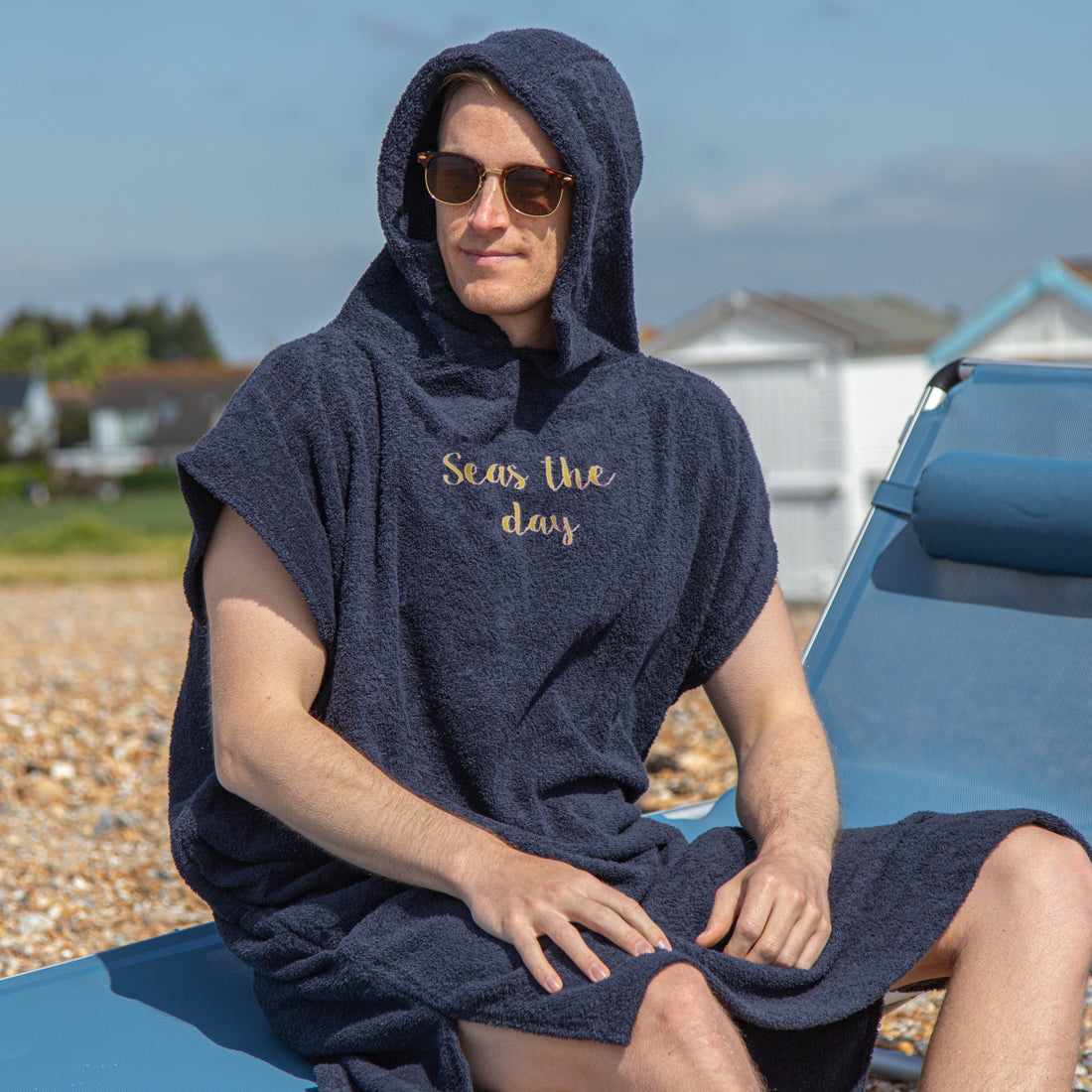 man wearing changing robe at the beach