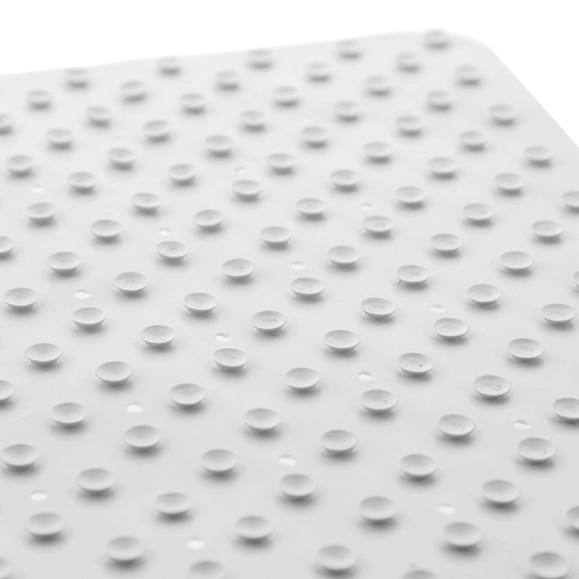 Suction cups of white anti-fungal rubber shower mat on white backdrop