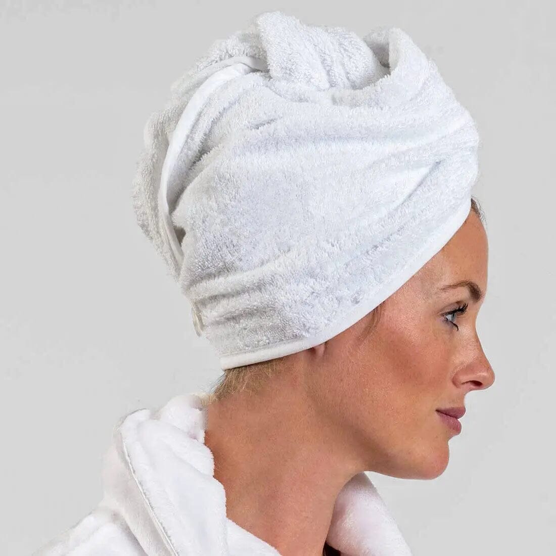 A female wearing a white Aztex Luxury Hair Turban Towel 