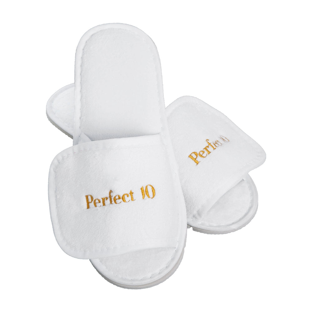 A pair of white plush adjustable
 slippers with 'Perfect 10' embroidered in gold on the top, shown on a plain white background.