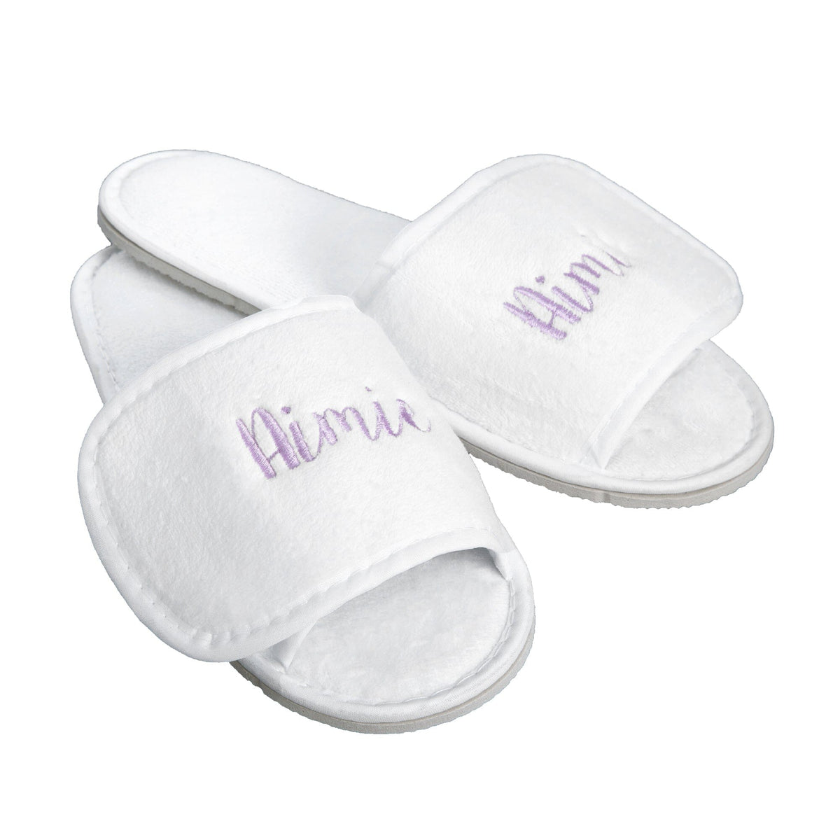 A pair of white plush open-toe slippers with the name 'Aimie' embroidered in lavender script on the straps, shown on a plain white background.