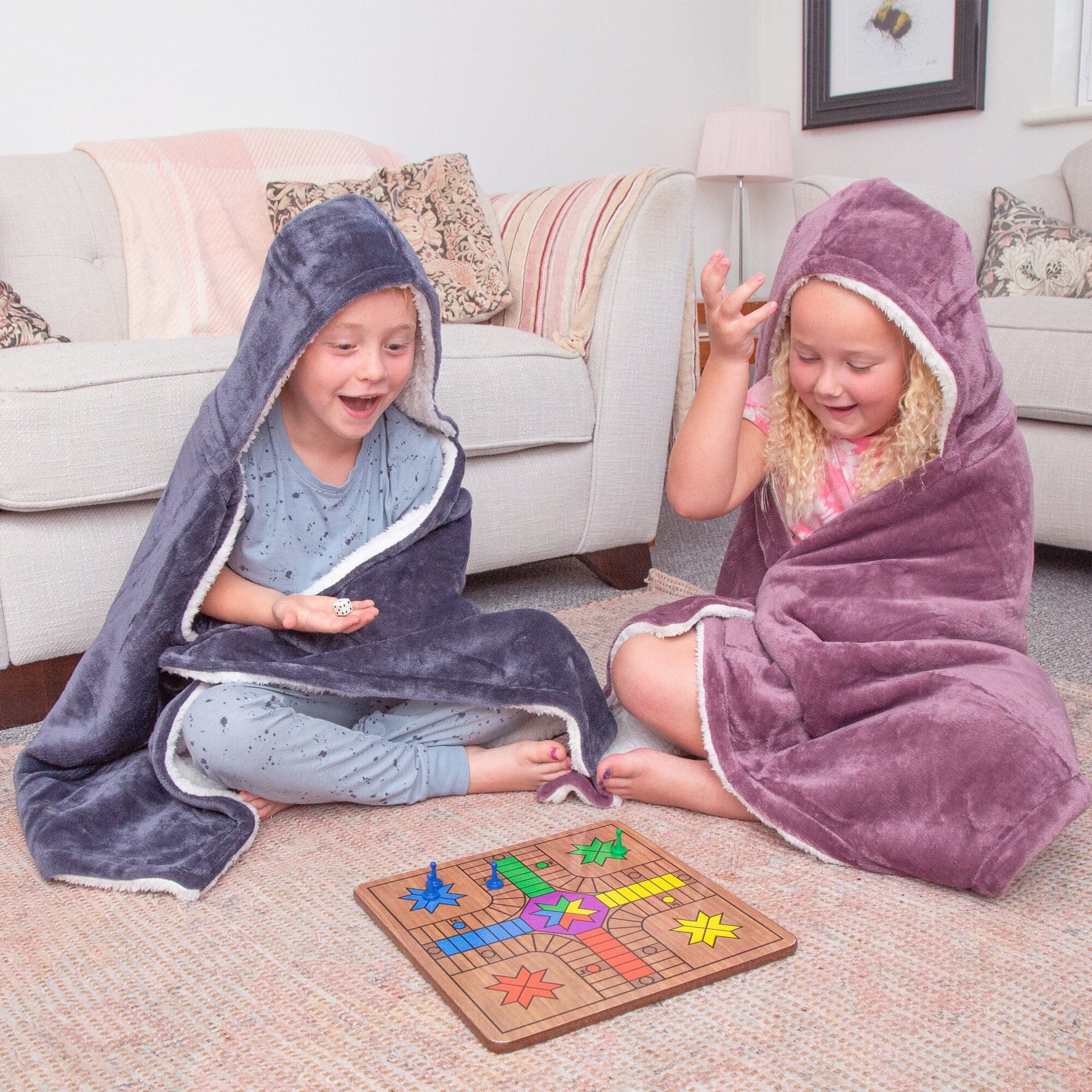 Two Kids playing a game wearing Hooded Sherpa Blanket