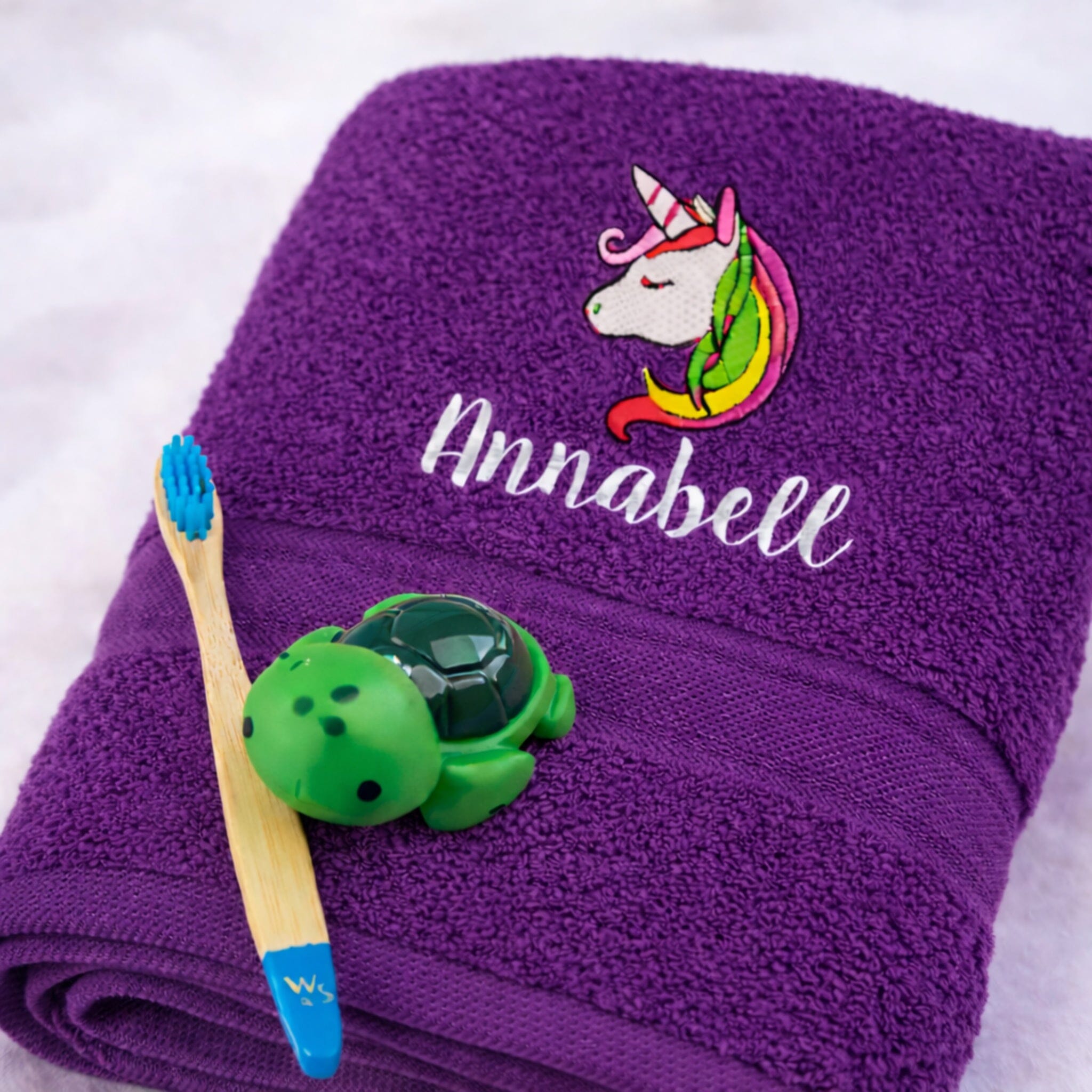 name on purple bath towel