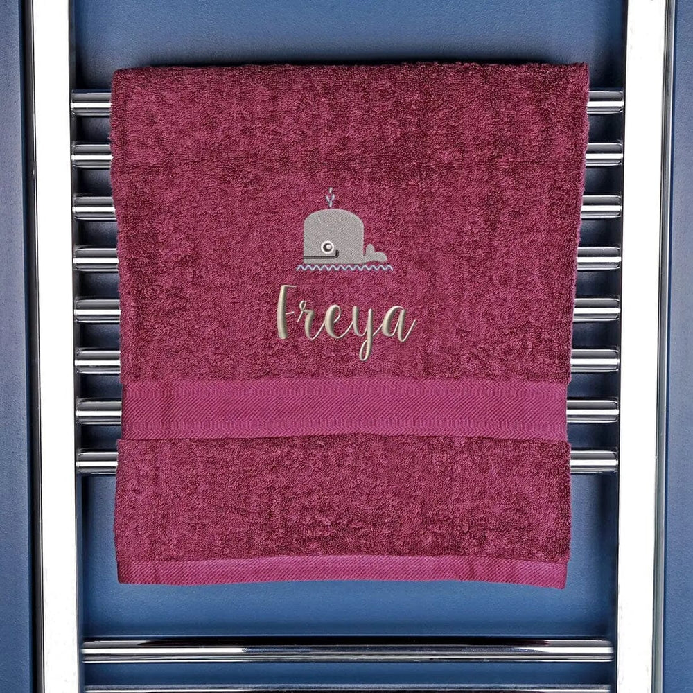bath towel in dark purple with whale logo and name