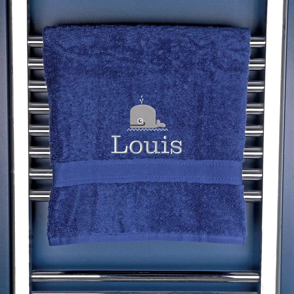 navy blue bath towel embroidered with a whale design and a name