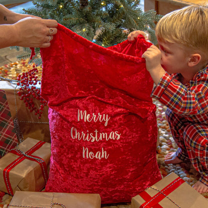 child opening a personalised Christmas Gift Sack