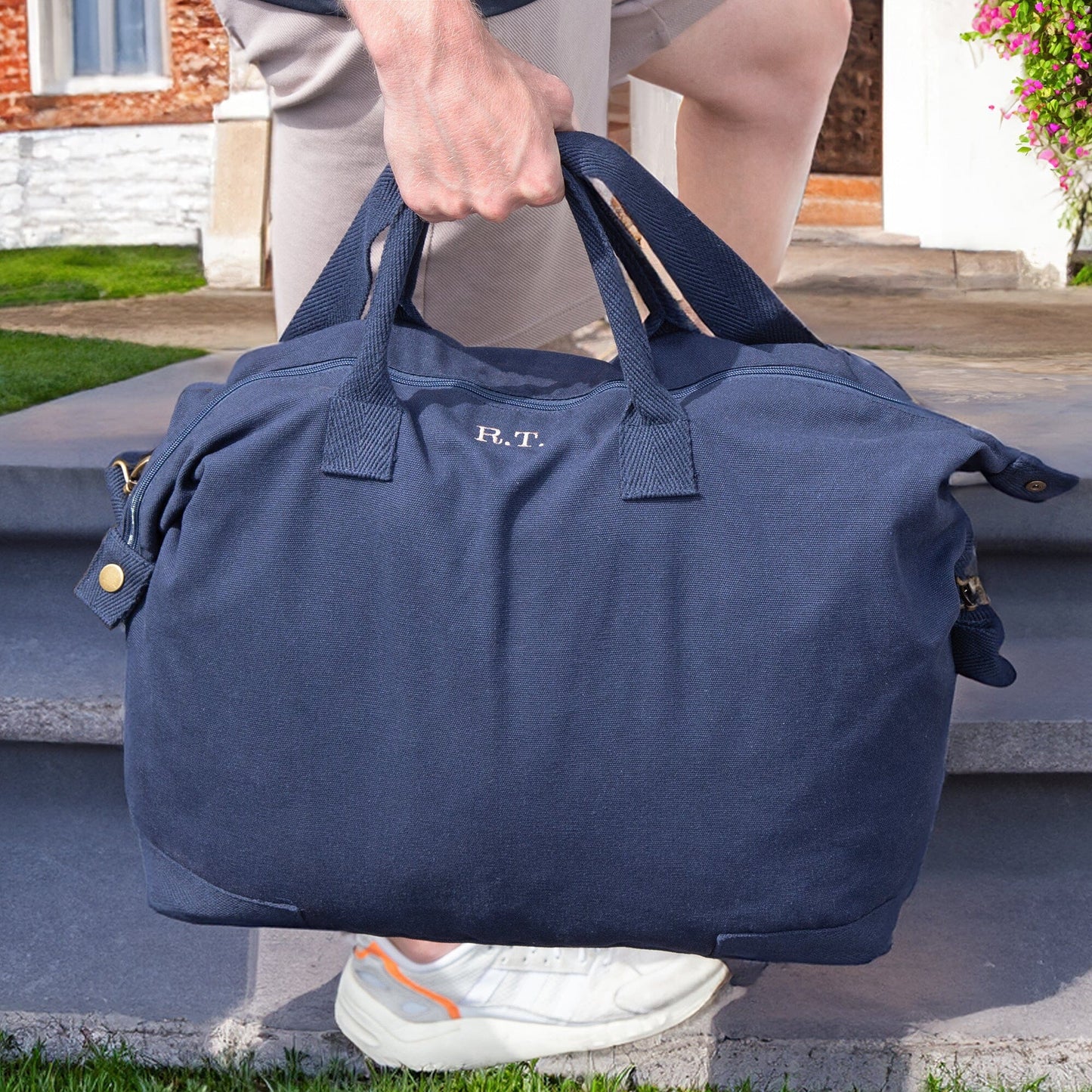 Outdoor scene of a man carrying a navy personalised recycled canvas bag