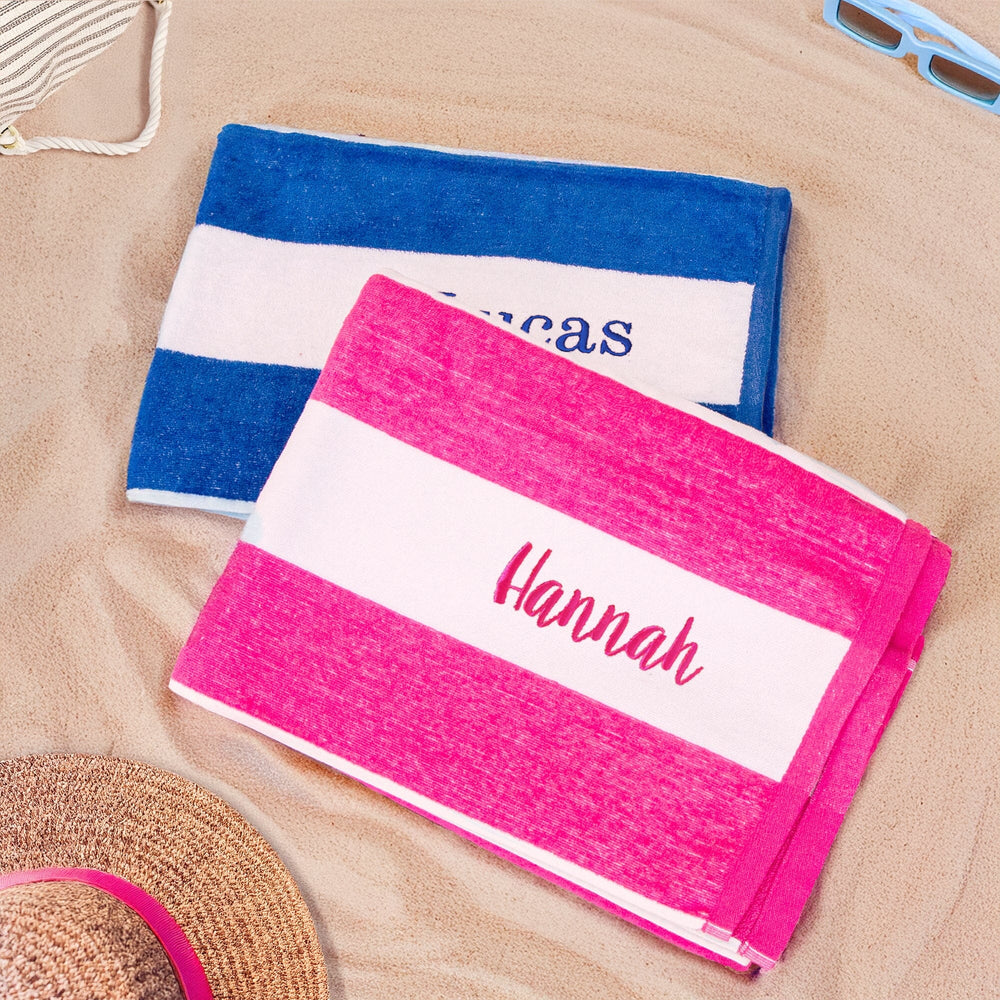 two striped cabana towels on the beach