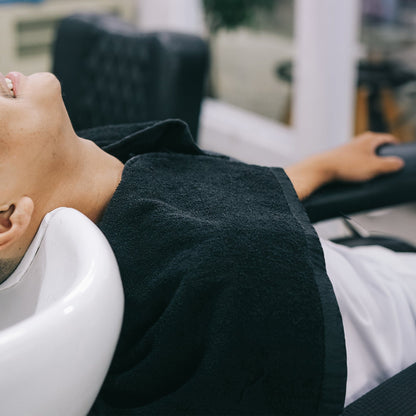 hair dressign towel  around neck of a male model in a spa