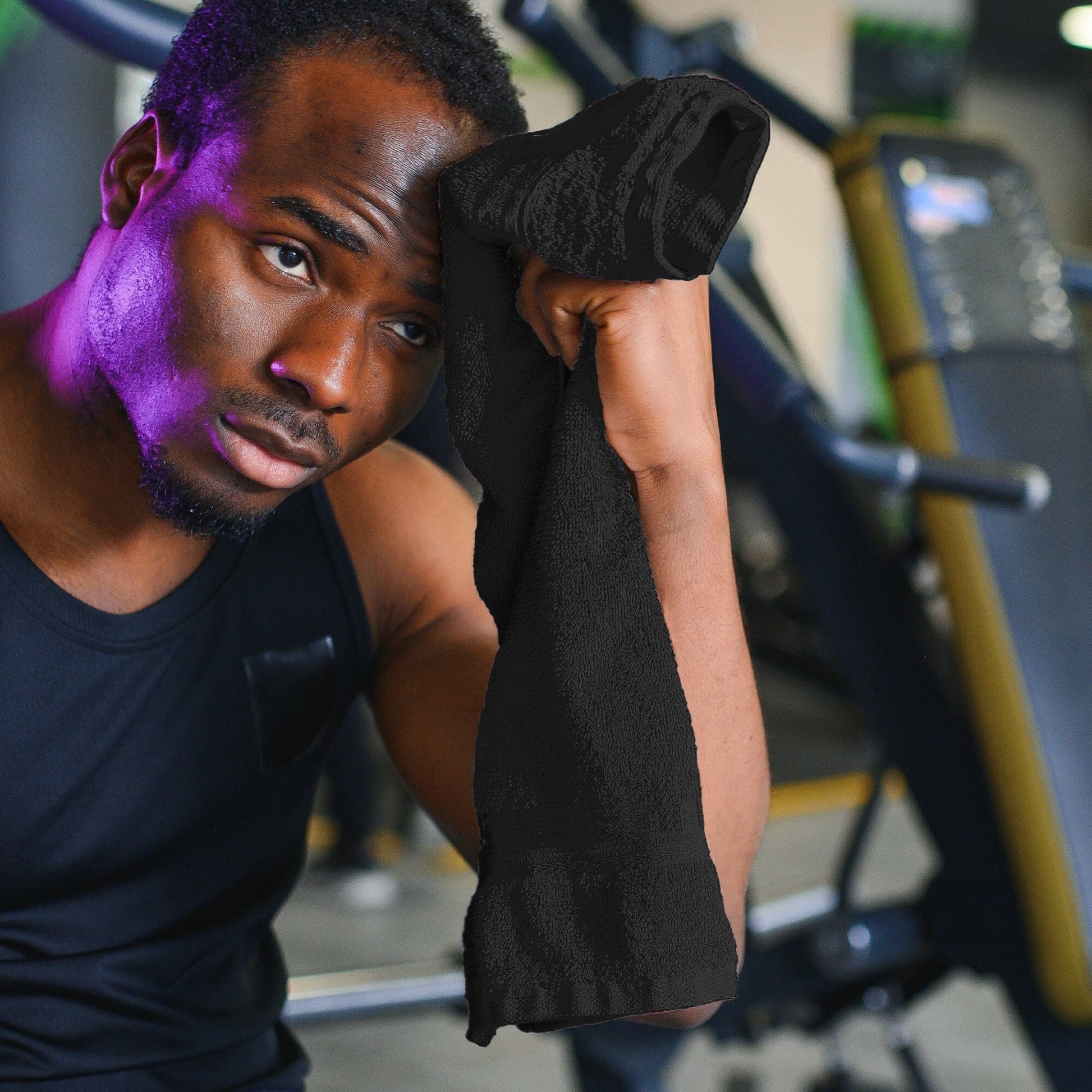 hair dressing towel getting used as a gym towek by a black male in a gym