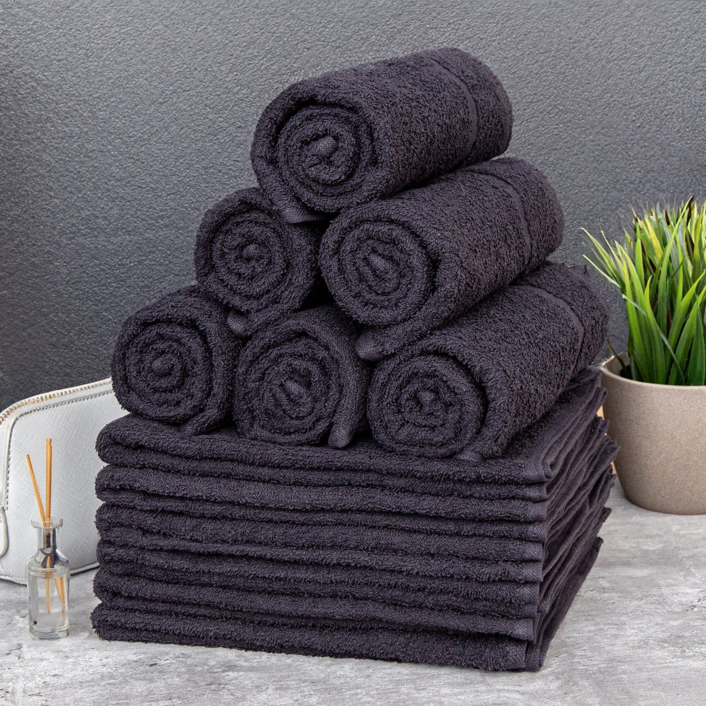 A stack of black hair dressing towels 