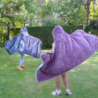 Two Kids wearing Personalised Hooded Sherpa Blanket in a garden