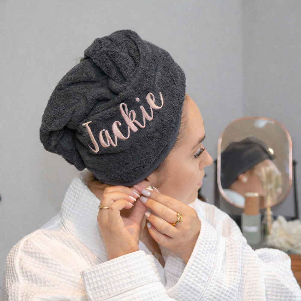 Rose coloured thread on black hair towel