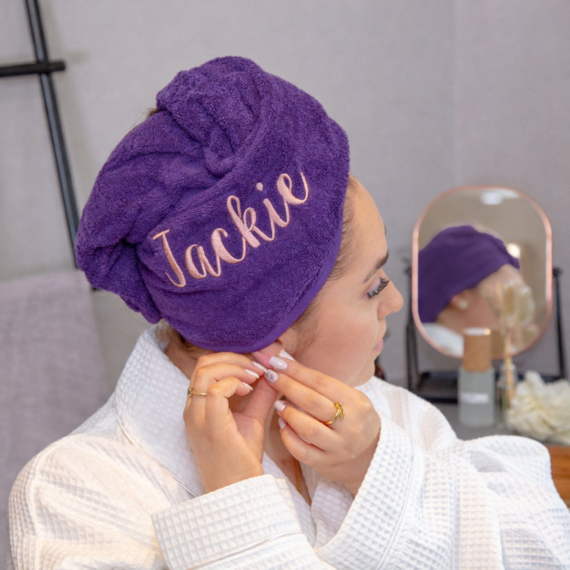 Rose coloured thread on purple hair towel