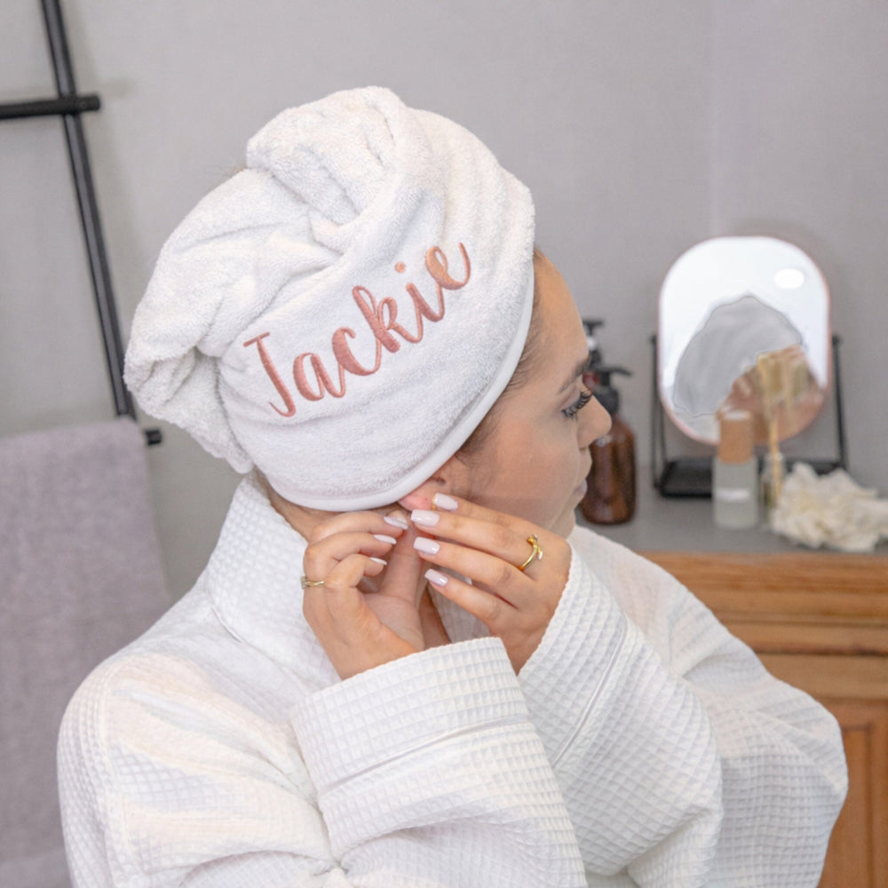 Rose coloured thread on white hair towel