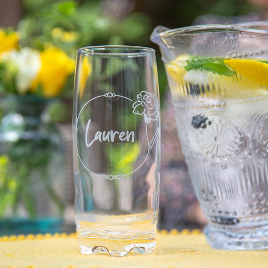 Personalised Birth Flower Hi Ball Glass Tumbler on the table in the garden