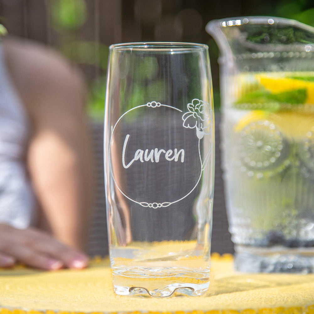 Personalised Birth Flower Hi Ball Glass Tumbler on the table in the garden