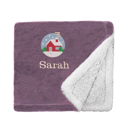 Lavender Personalised Cosy Christmas Mini Sherpa Blanket With Embroidered Festive Cottage Design on White Backdrop