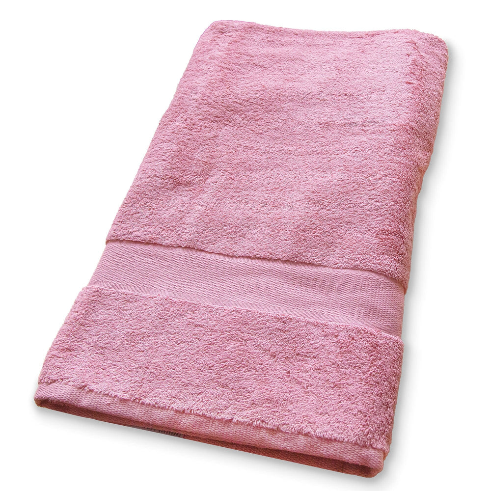 A folded pink cotton towel with a textured terry body and a ribbed band, shown on a plain white background.