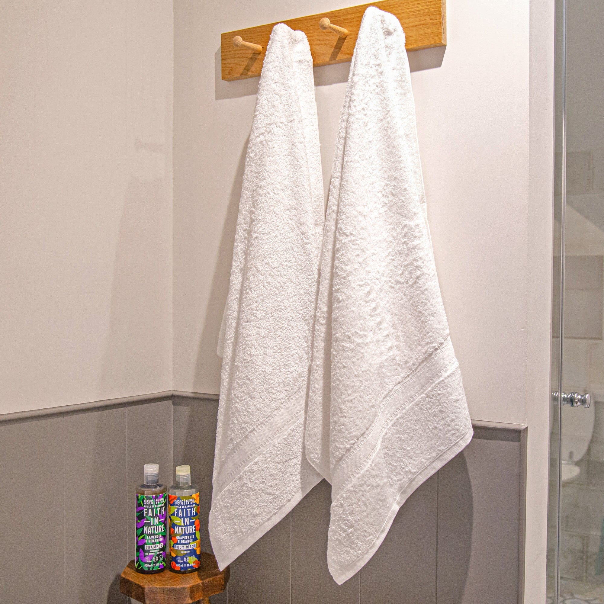 2 bath sheets hanging on hooks