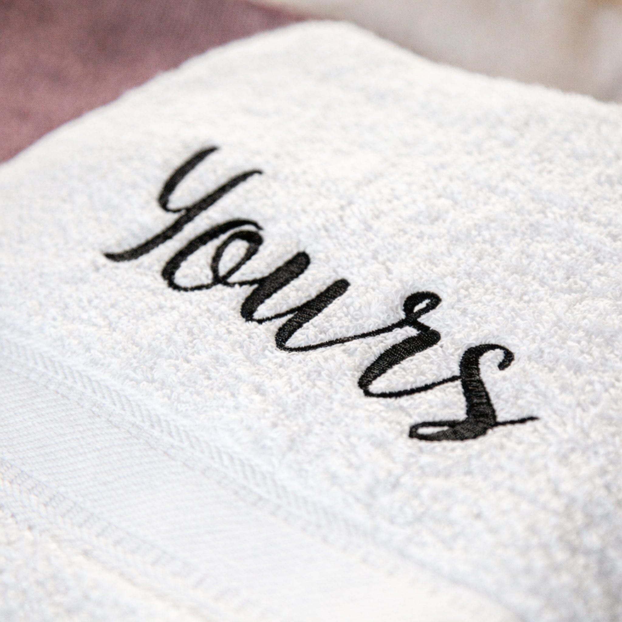 black thread on white bath towel