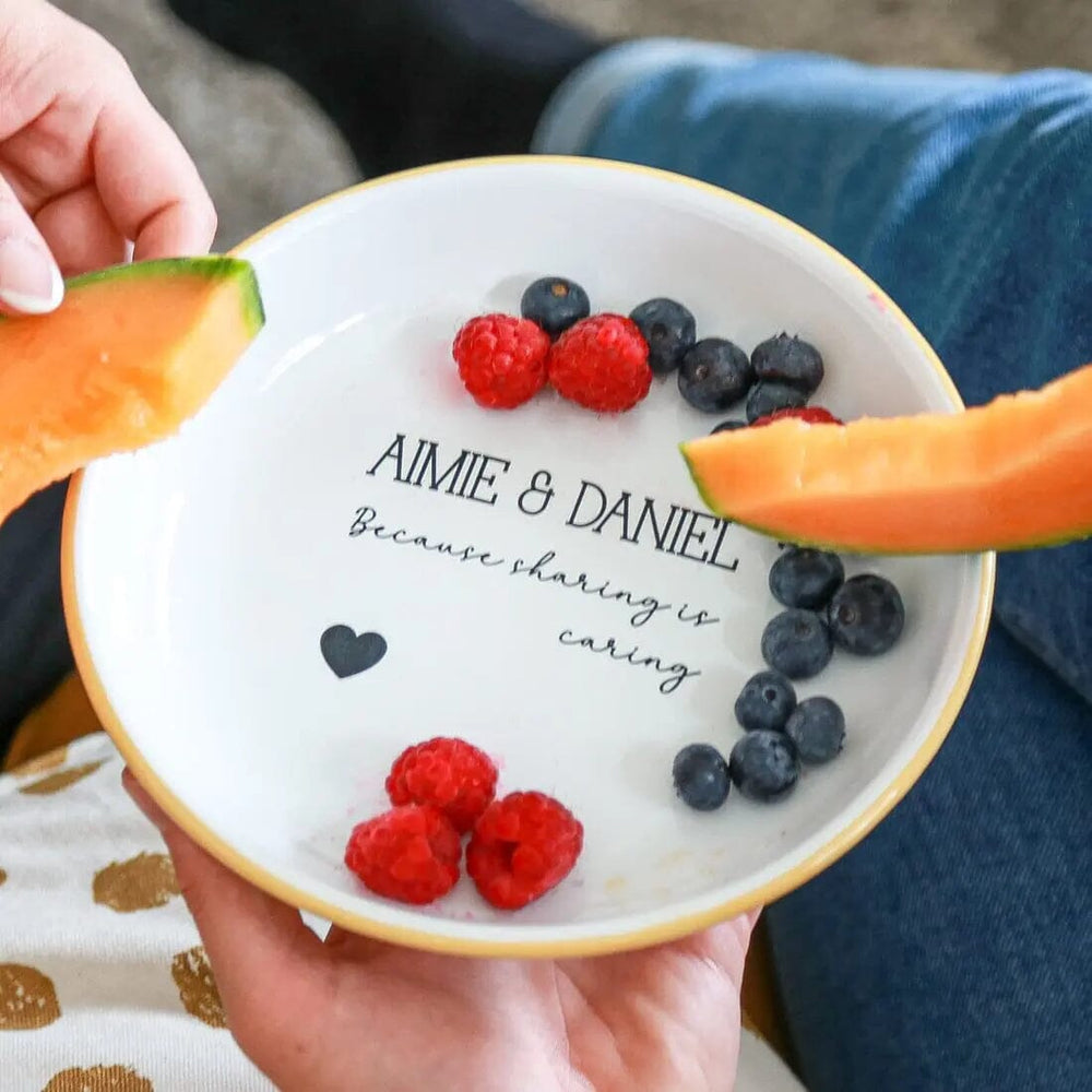 A couple sharing fruit from Personalised Enamel Sharing Snack Bowl   