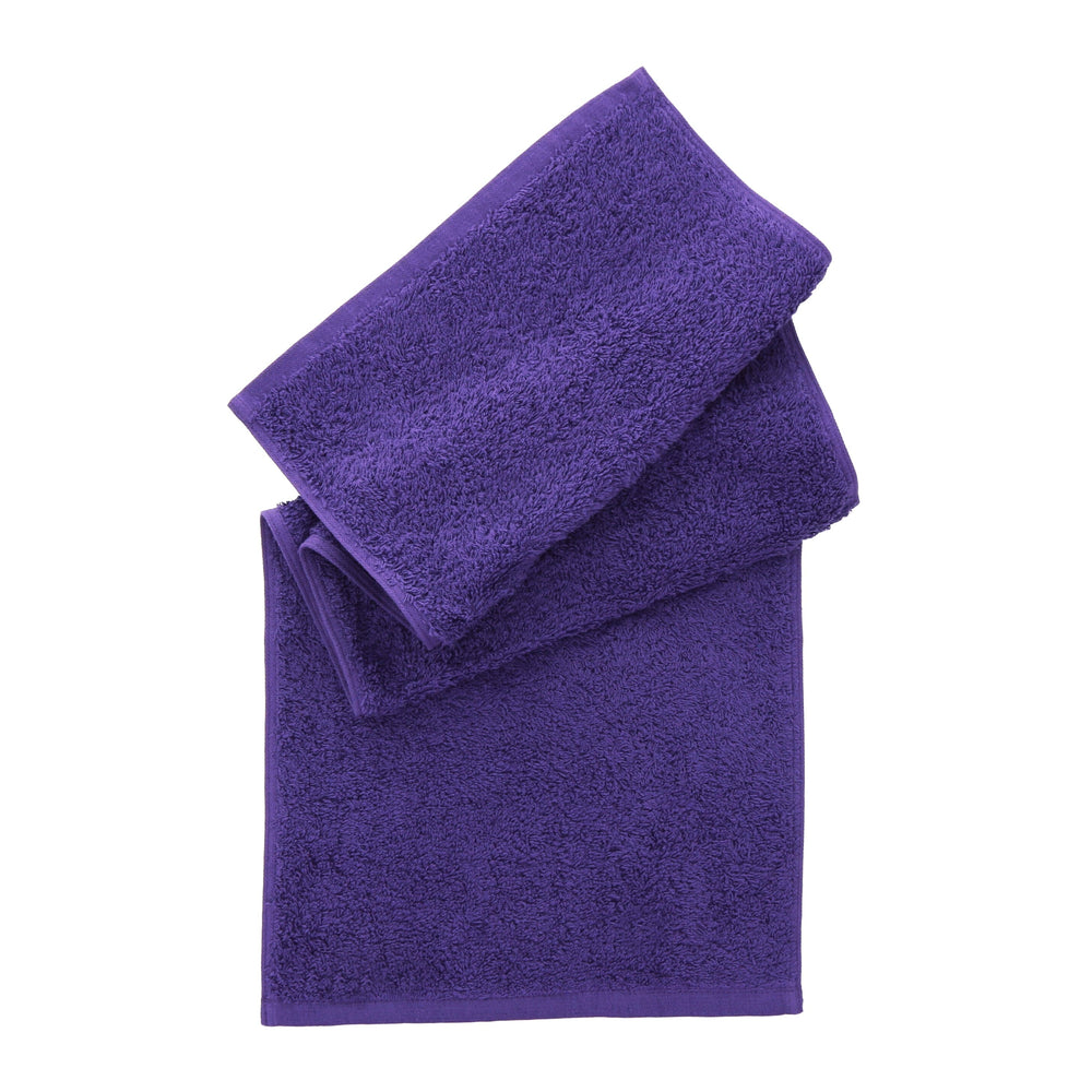 Two folded purple towels stacked on a plain white background, with the larger bath towel underneath and a smaller hand towel on top.