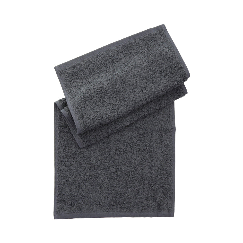Folded grey towel folded on a plain white background