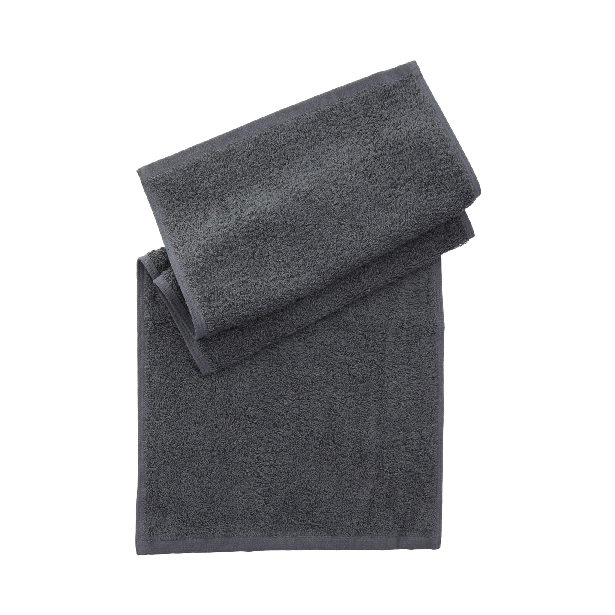 Folded grey towel folded on a plain white background