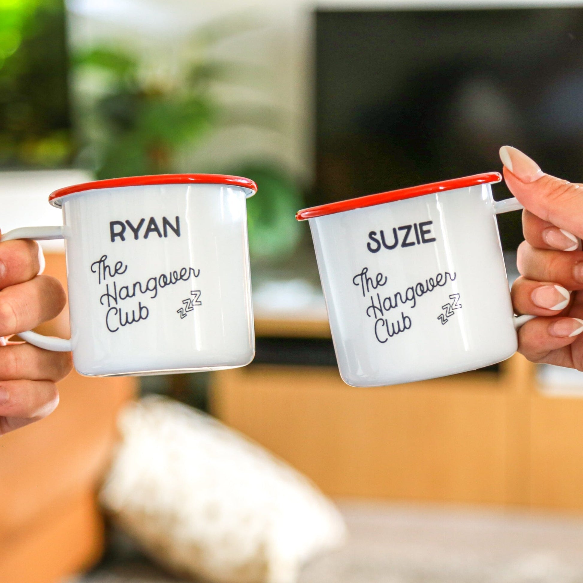 A couple holding Personalised Hangover Club Enamel Mug Set Of Two 