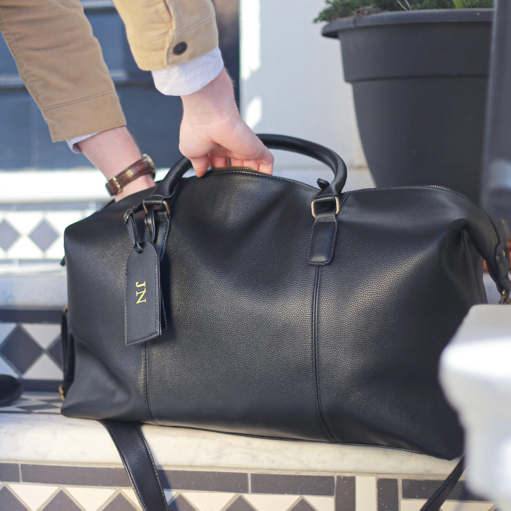 Black Personalised Luggage Tag And PU Leather Holdall Set on the outdoor stairs