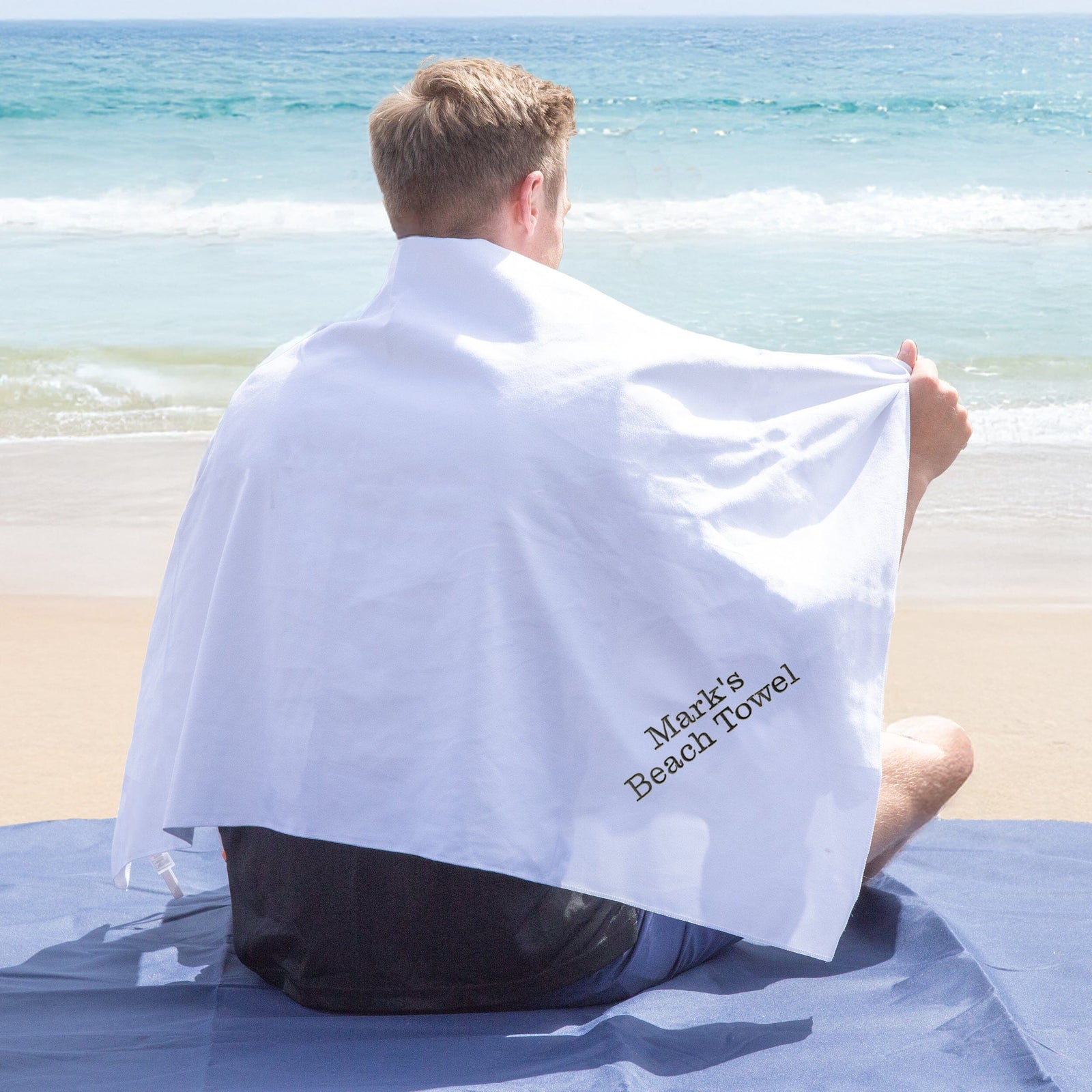 Man on the beach with a Personalised Microfibre Beach Towel