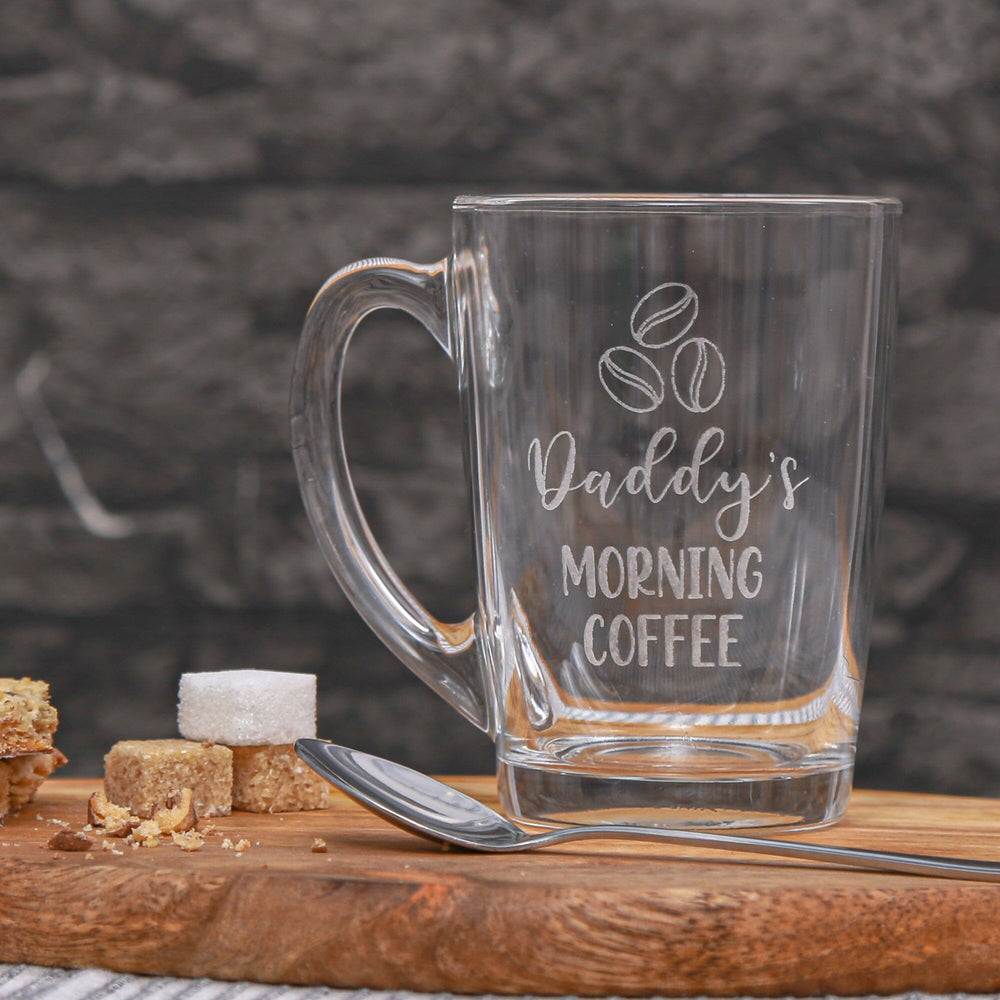 Empty Personalised Morning Coffee Glass Mug on the table with sugar cubes next to it  