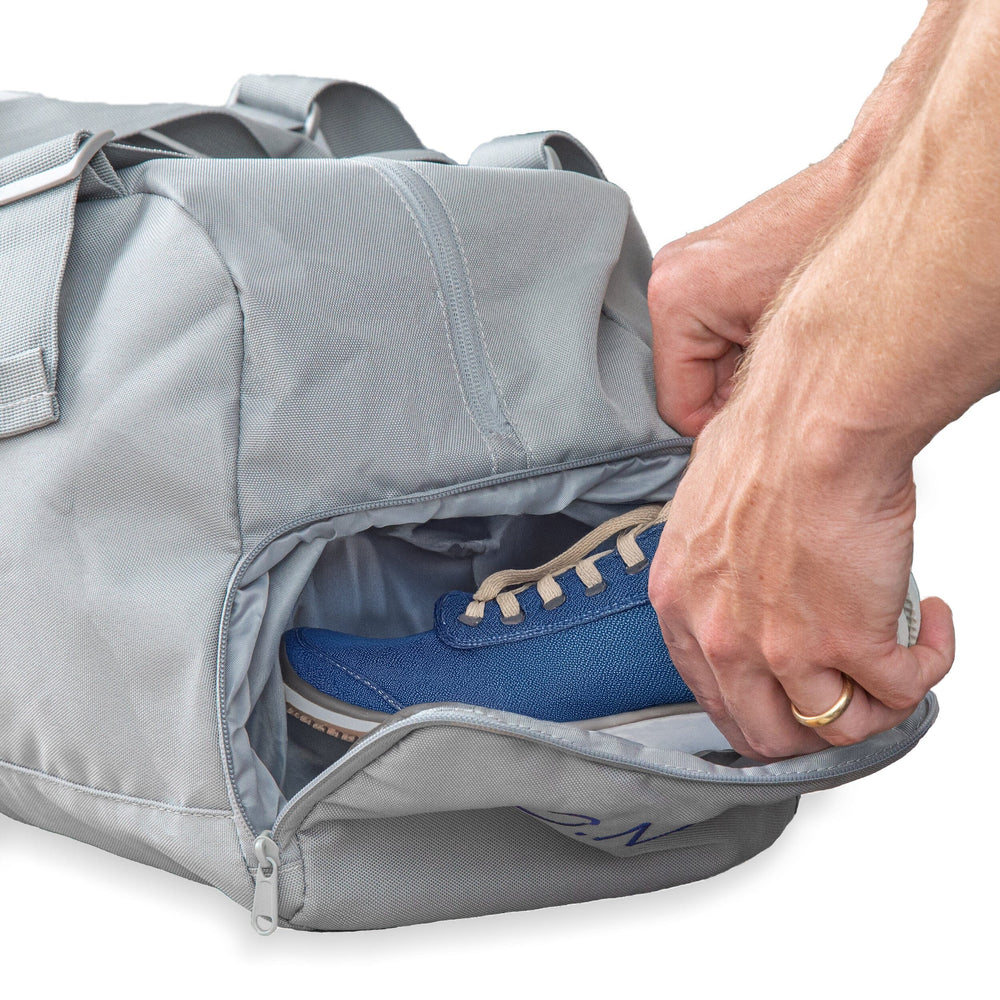 man putting a shoe into a bag