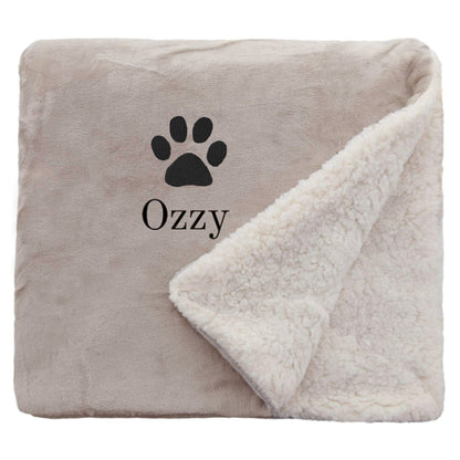 Taupe Personalised Sherpa Dog blanket with a pawprint design and personalisation of 'Ozzy'
