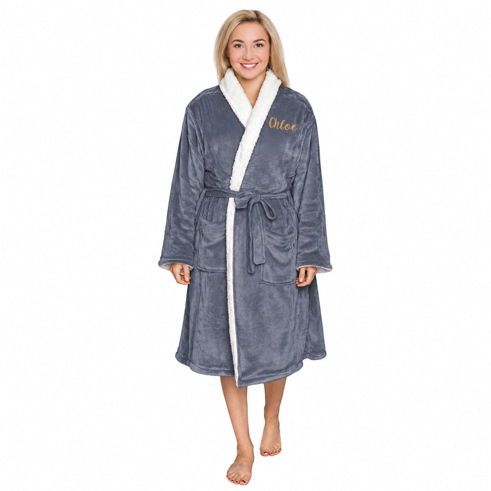 Woman wearing a slate plush personalised sherpa robe with 'Chloe' embroidered on it against a white background