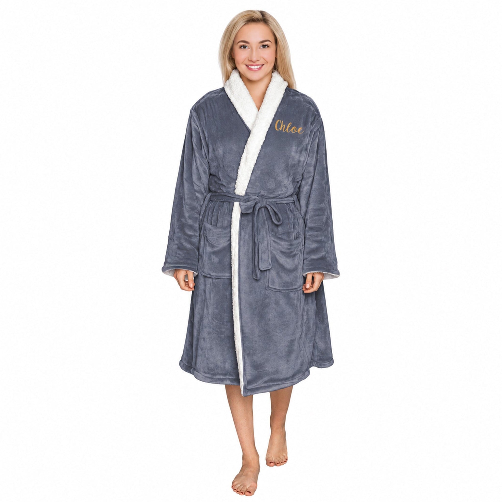 Woman wearing a slate plush personalised sherpa robe with 'Chloe' embroidered on it against a white background