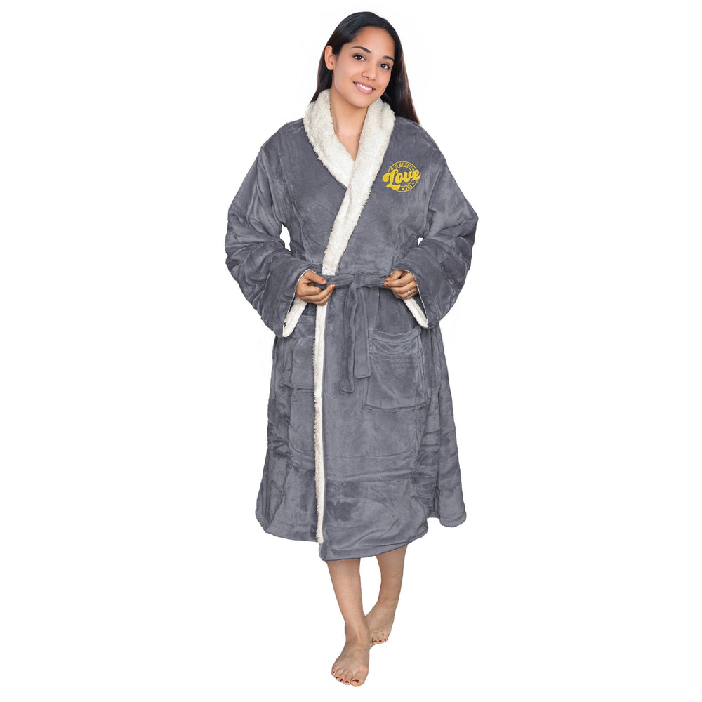 Woman wearing an embroidered Slate sherpa robe with 'Self Love Era' logo, on a white backdrop