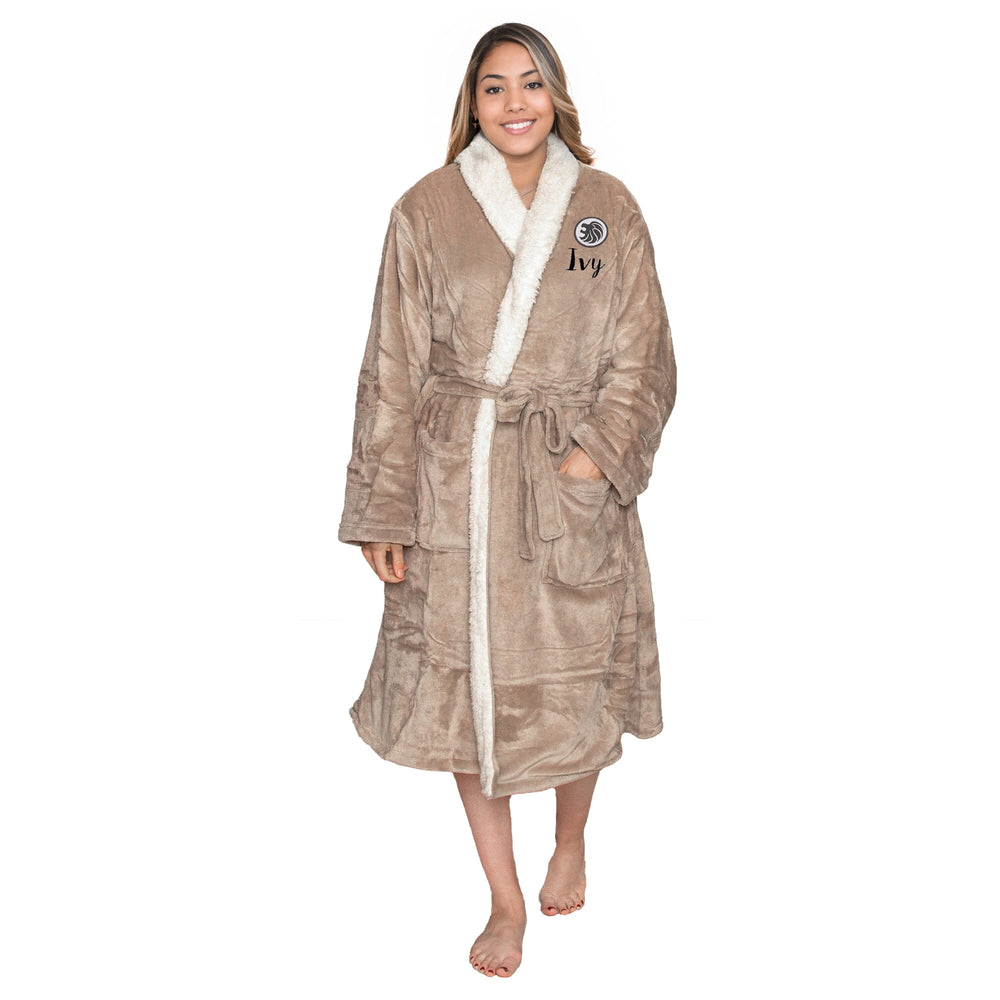 Woman wearing a personalised taupe sherpa plush robe with a zodiac Leo logo and a personalised, on a white background