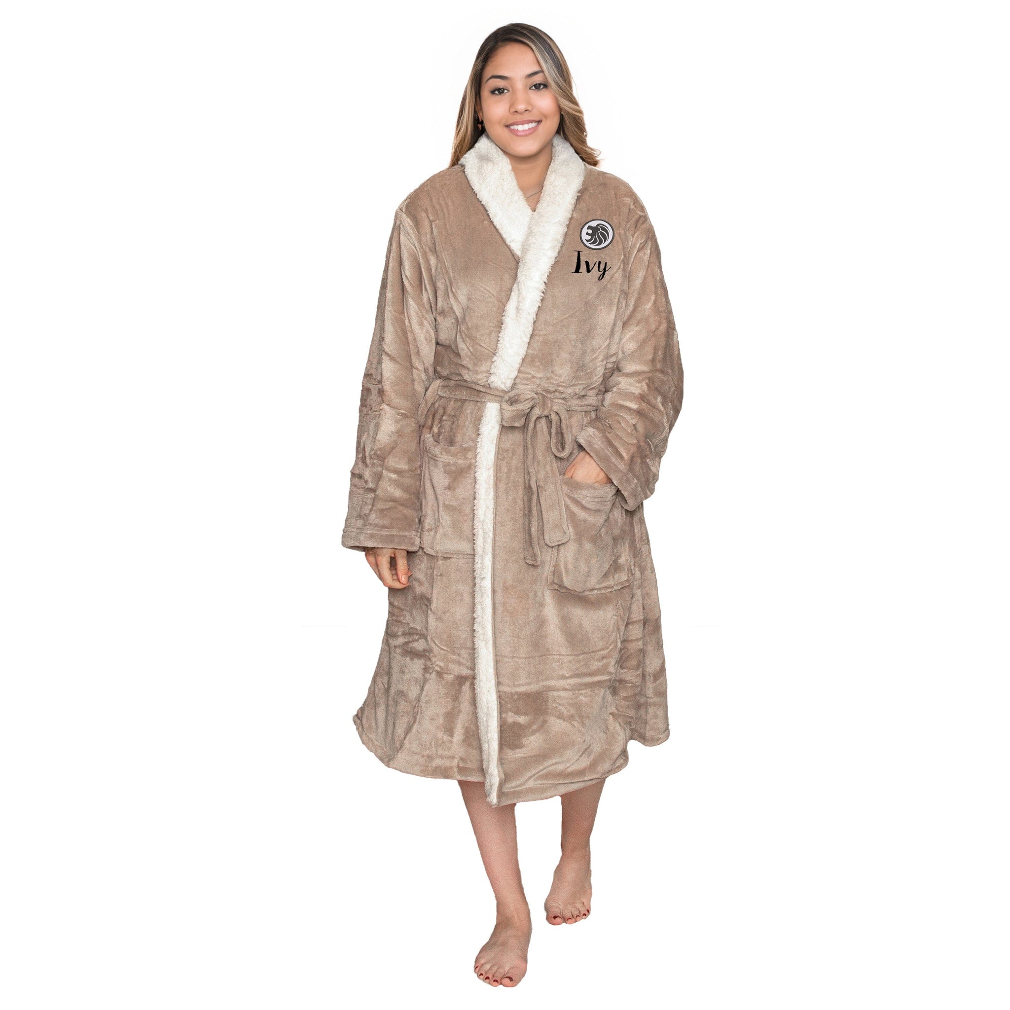 Woman wearing a personalised taupe sherpa plush robe with a zodiac Leo logo and a personalised, on a white background