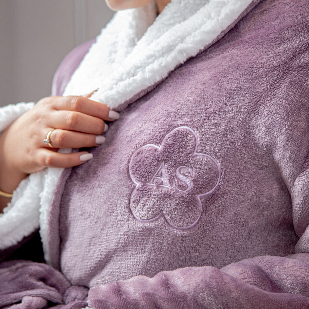 closeup of a Female wearing a personalised sherpa lavender robe with a flower design.