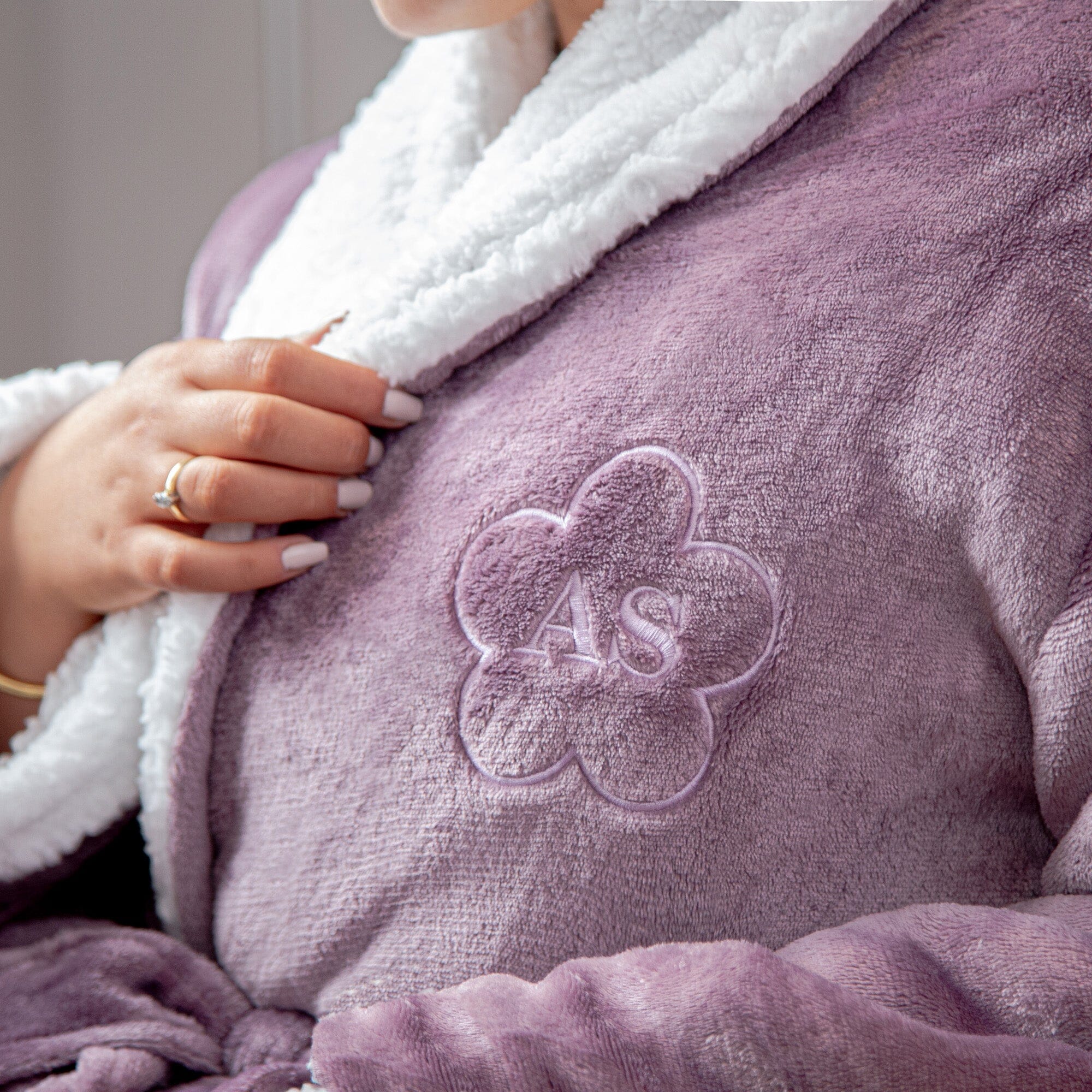 closeup of a Female wearing a personalised sherpa lavender robe with a flower design.