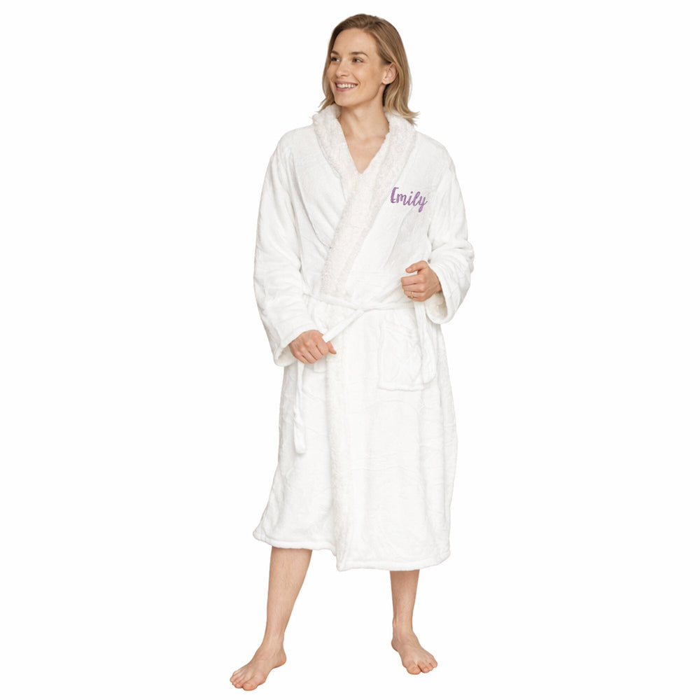 Woman wearing a white robe with 'Emily' embroidered on it against a white background